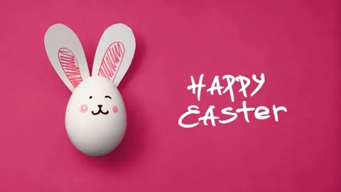 Horizontal 4K video. Text Happy Easter, egg with bunny face and ears on pink Stock Footage 308127416