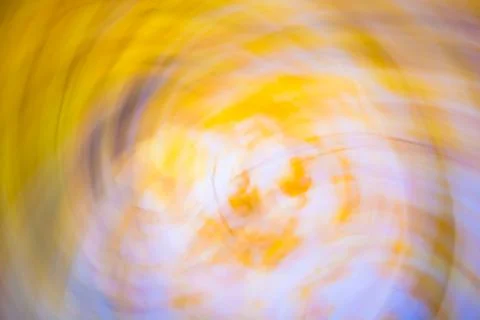 Horizontal abstract twisted background of motion blurred yellow leaves and sk Stock Photos