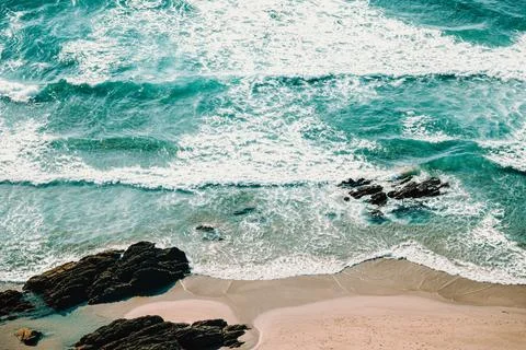 Horizontal aerial view of the waves over the sand of the beach Stock Photos