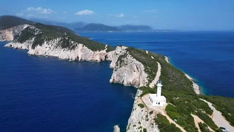Horizontal Aerial View of White Lighthouse on Cliff by Sea Photos