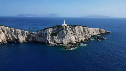 Horizontal Aerial View of White Lighthouse Standing on Majestic Cliff Stock Photos