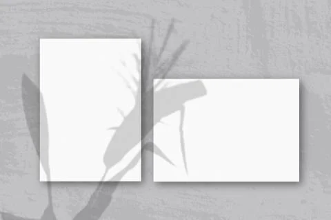 Horizontal and vertical sheets of white textured paper against a gray wall ba Stock Illustration