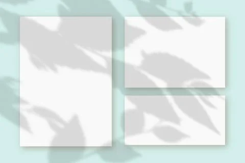Horizontal and vertical sheets of white textured paper against a blue wall Stock Illustration