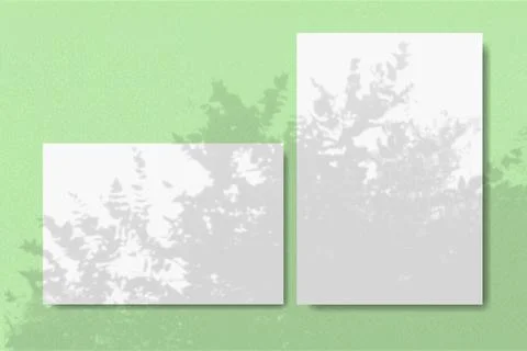 Horizontal and vertical sheets of white textured paper against a green wall Stock Illustration