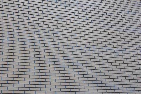 Horizontal arrangement of light gray bricks creates a modern wall design Stock Photos