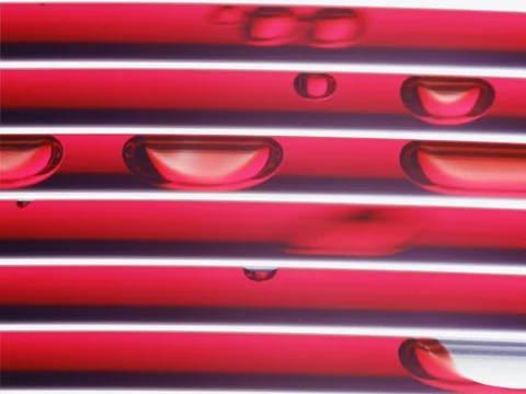 Horizontal array of transparent tubing pumping red liquid and air Stock Footage 72870439