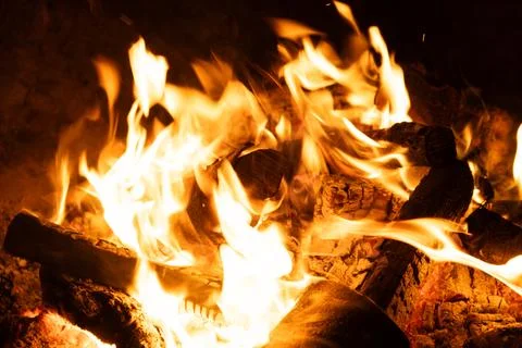 Horizontal Background of Firewood Heating up with Bright Flames. Stock Photos