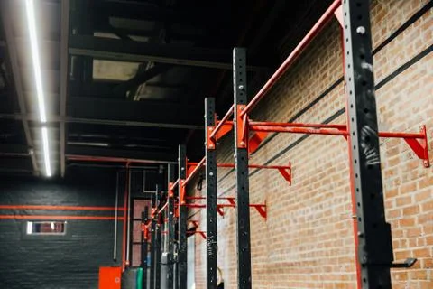Horizontal bar in Loft big empty interior of the gym for fitness workout. Stock Photos