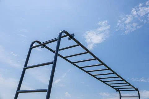 Horizontal bars in a park under a clear blue sky offer a great spot for out.. Stock Photos