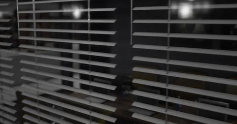 Horizontal blinds filter light in a dark room creating a serene atmosphere Stock Illustration