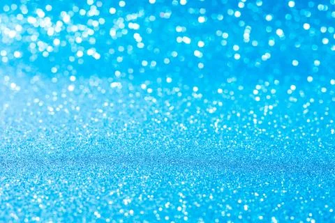 Horizontal blue glitter background with blur and bokeh Stock Photos
