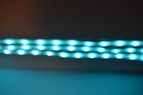 Horizontal Blue LED Light Strip Bokeh on Dark Background Stock Photos