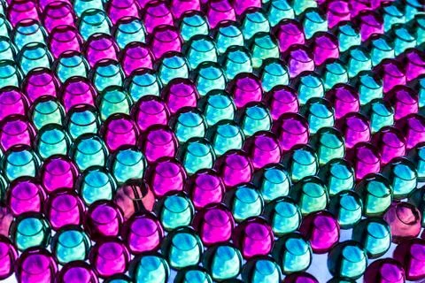 A horizontal bright colored texture of rainbow transparent hydrogel balls in Stock Photos