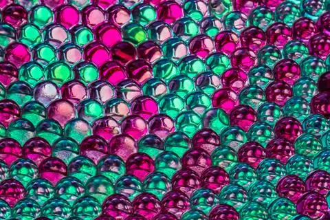 A horizontal bright colored texture of rainbow transparent hydrogel balls in 스톡 사진