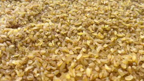 Horizontal camera flyover above raw bulgur wheat groats macro texture Stock Footage 336506998
