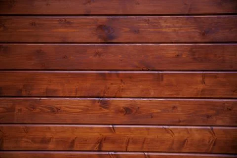 Horizontal cedar plank wall with knots, grain swirls, and seams Stock Photos