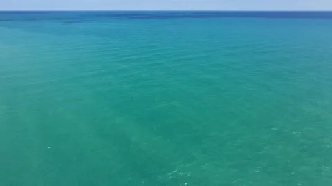 Horizontal circular drone footage over turquoise Lake Michigan Stock Footage 343546488