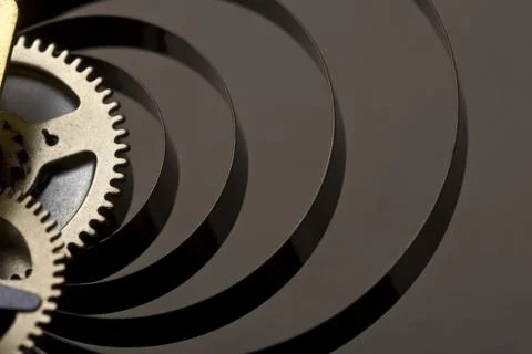 Horizontal close up on the golden cogs of a mechanical clock Photos