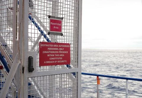Horizontal Close-Up of Restricted Area Warning Signs on a Ship Metal Gate, Ocean Stock Photos