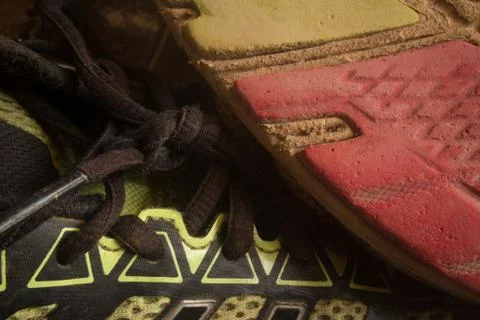 Horizontal close up of sole of worn running  shoe, positioned diagonally, wit Stock Photos