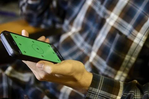 Horizontal closeup of man using smartphone indoors Stock Photos