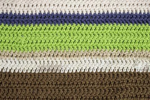 Horizontal colored crochet lines pattern, beige, blue, green and brown colors Stock Photos