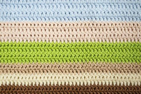 Horizontal colored crochet lines pattern, beige, blue, green and brown colors Foto stock