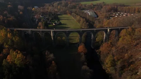 Horizontal Drone Flight Above Old Mountain Viaduct Surrounded by Autumn Forest Stock Footage 320839784