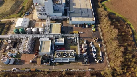 Horizontal drone pan across manufacturing complex infrastructure and extraction Stock Footage 339813012