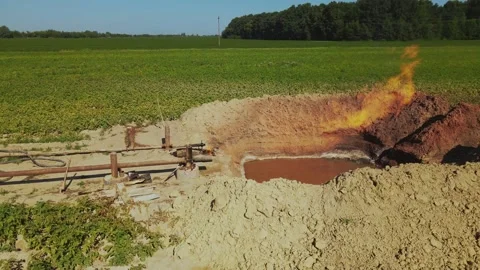 Horizontal drone shooting of burning fire. View of pit with substance. Gas Stock Footage 219953800