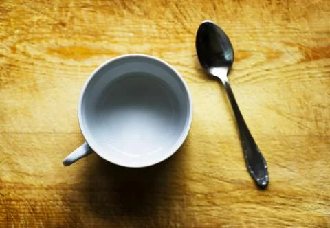 Horizontal empty cup with spoon bokeh background Stock Photos