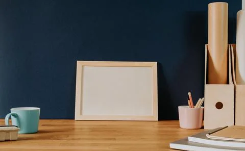 Horizontal empty frame on natural wooden desk Stock Photos