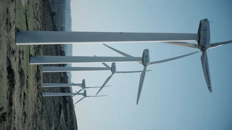 Horizontal footage of wind mill park at summer with pale blue sky. Stock Footage 169748333