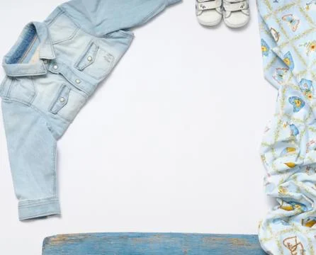 Horizontal frame of jeans stuff and sneakers for baby boy on white background Stock Photos