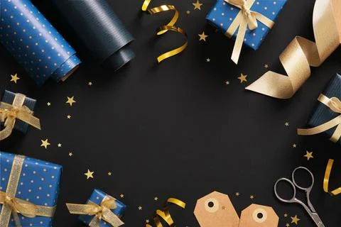 Horizontal frame made of gift wrapping materials. Blue wrapping paper, tags a Stock Photos