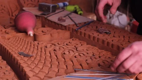 Horizontal Full HD video. Man restores brick religious slab with pattern Stock Footage 268073527