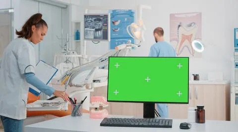 Horizontal green screen on computer in dental cabinet Stock Photos
