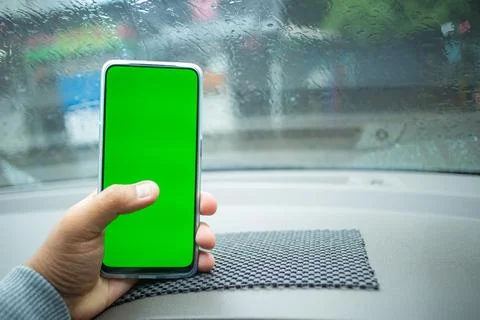 Horizontal Green Screen Smartphone Held by Hand in Rainy Car Stock Photos