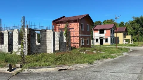 Horizontal ground level view of pathway leading toward a clean unfinished house Video stock 332600263