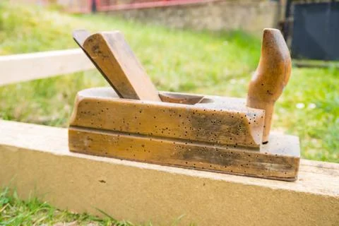 Horizontal high angle angle studio shot of small vintage old wood planer Photos