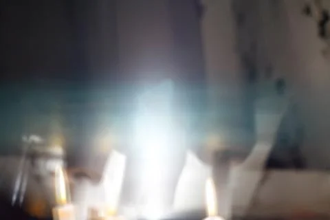 Horizontal image of abstract bokeh light in a night unfocused candles. Stock Photos