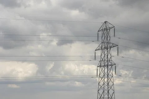 Horizontal image of electricity pylon and power lines, with overcast sky. Stock-Fotos
