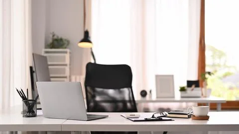 Horizontal image of laptop computer, documents and various office supplies on Stock Photos