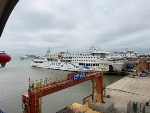 Horizontal Large passenger ferry docked at Haikou port in Hainan Stock Photos