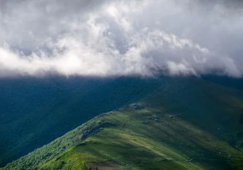 Horizontal layer of clouds skims the peaks of the Sierra de Ancares Stock Photos
