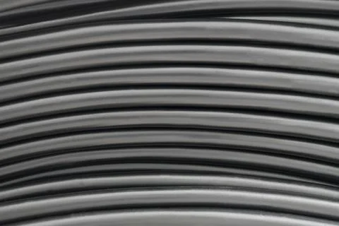 Horizontal lines of black electric cable. Abstract textural industrial backgr 库存照片