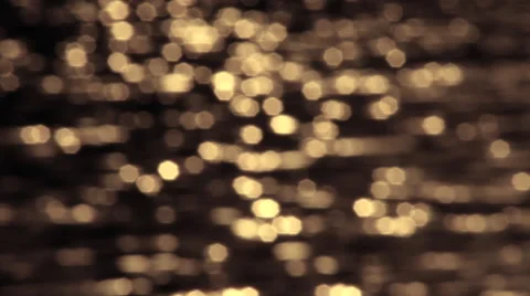 Horizontal lines of playing yellow specks on the brown background out of focus. Stock Footage 41407377