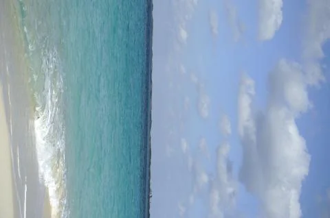 Horizontal lockup of blue ocean beach side with blue sky Stock Photos