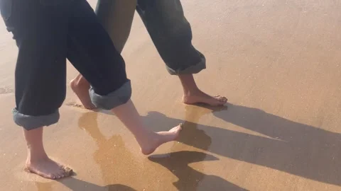 Horizontal Low-Angle View of Barefoot People Walking on Sandy Beach Stock Footage 340774818