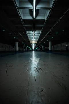 Horizontal low angle view of an empty underground parking Stock Photos